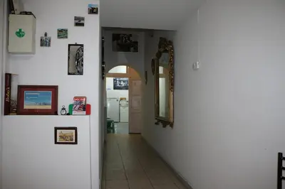 a hallway with a mirror and some pictures on the wall at Roman Place in Rome