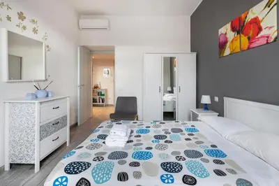 a bedroom with a bed and a chair in it at Lilli Home Holidays in Rome