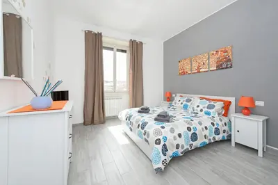a white bedroom with a bed and a window at Lilli Home Holidays in Rome