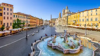 a street with a fountain in the middle of a city at Lilli Home Holidays in Rome