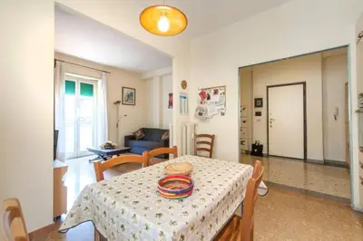 a living room with a table and chairs and a living room at Magnifico Cozy Apartment 400m da metroB in Rome