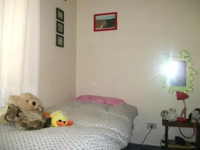 a bedroom with a bed with stuffed animals on it at Magnifico Cozy Apartment 400m da metroB in Rome
