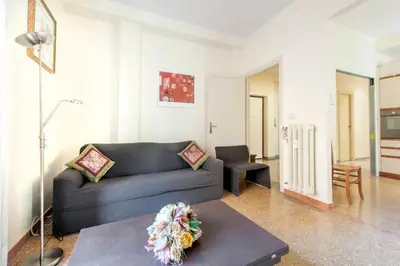 a living room with a couch and a table at Magnifico Cozy Apartment 400m da metroB in Rome