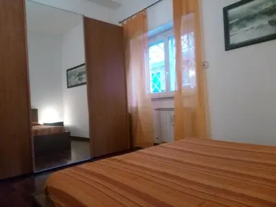 a bedroom with a bed and a window and a door at La Casa di Nonna Betta in Rome