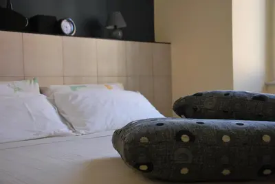a bedroom with a bed with two pillows at B&B Casa Torpì in Rome
