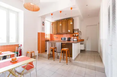 a kitchen with wooden cabinets and a table and chairs at B&B Casa Torpì in Rome