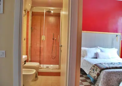 a bedroom with a shower and a bed and a bathroom at B&B Casa Torpì in Rome