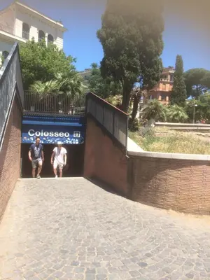 two people are standing in a doorway of a wall at CASA VACANZA COLOSSEO WHOLE HOLIDAY HOME APARTMENT da PAMINO & PRISCILLA in Rome