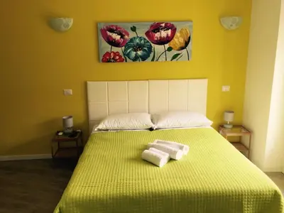 a bedroom with a bed with two towels on it at Affittacamere Roma Tiburtina in Rome