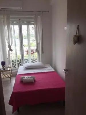 a bedroom with a bed with a red blanket at Affittacamere Roma Tiburtina in Rome