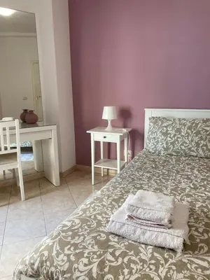a bedroom with a bed with two towels on it at Casa Vacanze Marzia in Rome