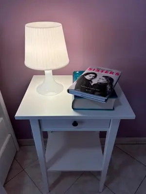 a white table with a lamp and a magazine on it at Casa Vacanze Marzia in Rome