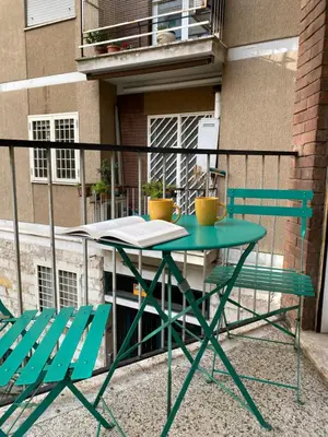 a green table and two chairs on a balcony at Casa Vacanze Marzia in Rome