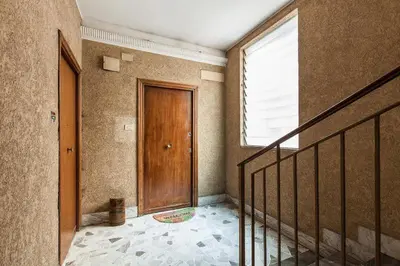 a hallway with a wooden door and a window at Casa Vacanze Marzia in Rome