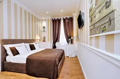 a hotel room with a bed and a television at Vatican Chic B&B in Rome