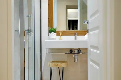 a bathroom with a sink and a stool and a mirror at Vatican Chic B&B in Rome