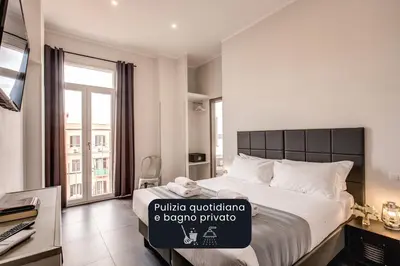 a bedroom with a large bed with a sign on it at Floor 6 Boutique Rooms by DOT Suites in Rome