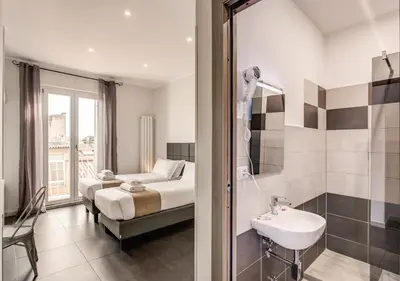 a bathroom with a bed and a sink in a room at Floor 6 Boutique Rooms by DOT Suites in Rome