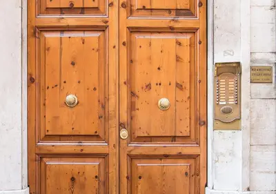 a wooden door on a building with a telephone at Floor 6 Boutique Rooms by DOT Suites in Rome