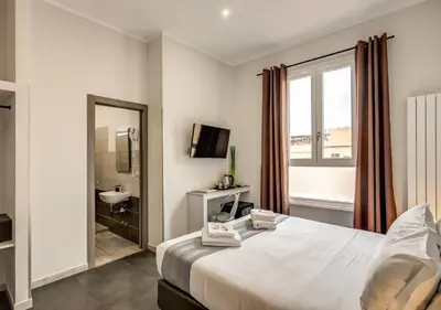 a bedroom with a bed and a sink and a mirror at Floor 6 Boutique Rooms by DOT Suites in Rome