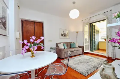 a living room with a white table and a couch at Mecenate Charme Apartment in Rome