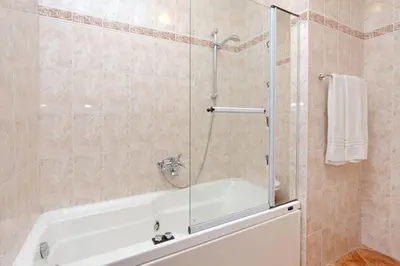 a bathroom with a shower with a white tub at Mecenate Charme Apartment in Rome
