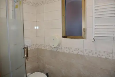 a bathroom with a toilet and a window at Roma Carina in Rome