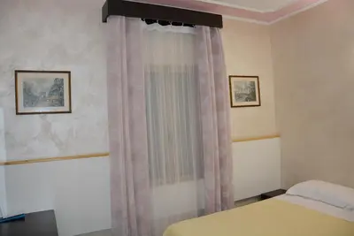 a bedroom with a bed and a window at Roma Carina in Rome