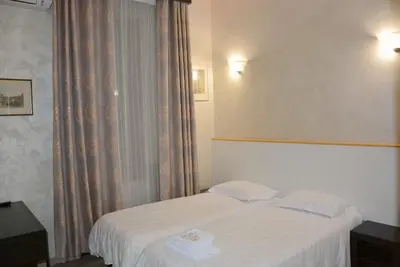 a hotel room with a bed and a window at Roma Carina in Rome