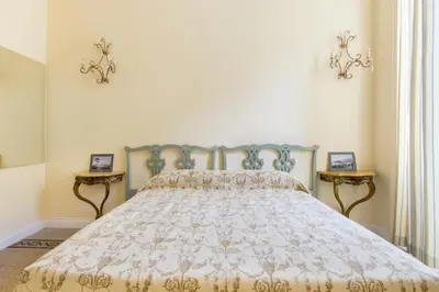 a bed in a bedroom with two side tables at Rome Charming Suites in Rome