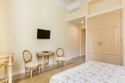a bedroom with a bed and a table and chairs at Rome Charming Suites in Rome