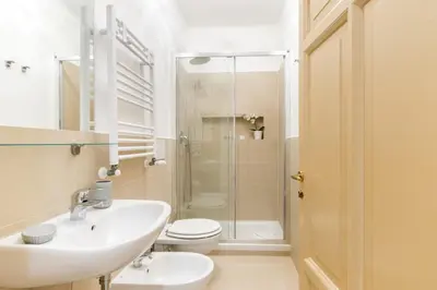 a bathroom with a sink and a toilet and a shower at Rome Charming Suites in Rome