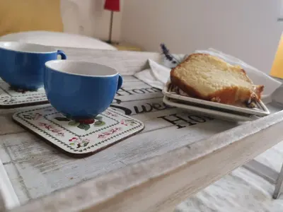 a table with a plate of bread and two cups at House Maximo near Vatican in Rome