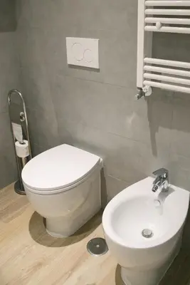 a bathroom with a white toilet and a sink at Vatican Garden Rooms in Rome