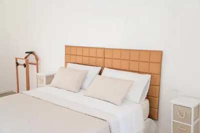 a bedroom with a bed with white sheets and pillows at Vatican Garden Rooms in Rome