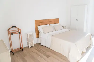 a bedroom with a large bed with a wooden headboard at Vatican Garden Rooms in Rome