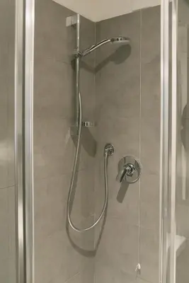 a shower with a glass door in a bathroom at Vatican Garden Rooms in Rome