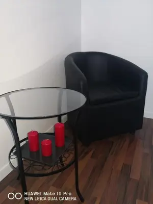 a black chair and a glass table and red cups at Trastevere four seasons Valadier in Rome