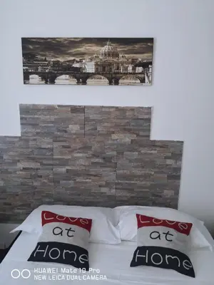 a bed with two pillows on top of it at Trastevere four seasons Valadier in Rome