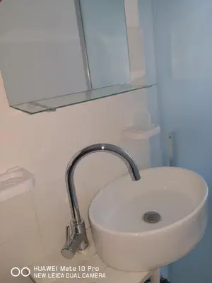 a white sink in a bathroom with a mirror at Trastevere four seasons Valadier in Rome