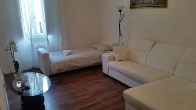a living room with a couch and a bed at Trastevere four seasons Valadier in Rome