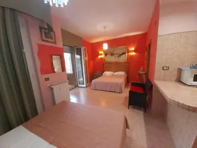 a bedroom with red walls and a bed in a room at Suites Oliveri Viale Marconi in Rome