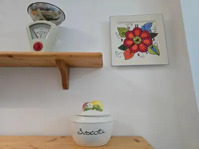 a room with two pictures on the wall and a plant on a dresser at Garden House in Rome