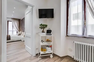 a white room with a tv on a wall at AS Vaticano Apartment in Rome