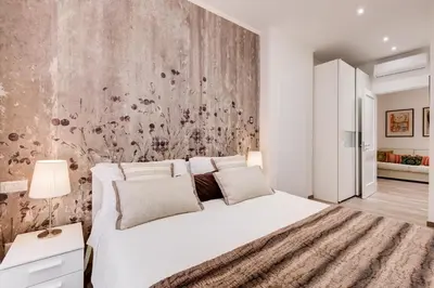 a bedroom with a white bed and a wall at AS Vaticano Apartment in Rome