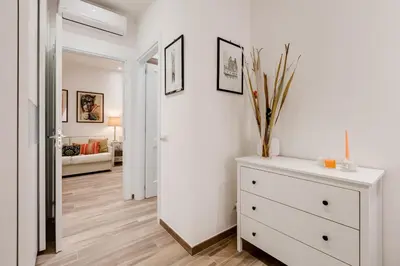 a room with a white dresser and a room with a bedroom at AS Vaticano Apartment in Rome