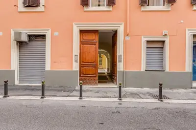 a orange building with a door in the middle of a street at AS Vaticano Apartment in Rome