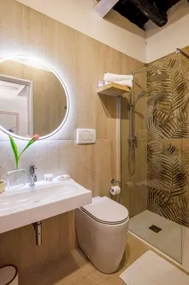 a bathroom with a toilet and a sink and a shower at Romanticasa Trastevere in Rome
