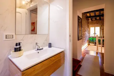 a bathroom with a sink and a mirror at Romanticasa Trastevere in Rome
