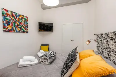 a bedroom with a bed with pillows on it at Julius Caesar Home in Rome